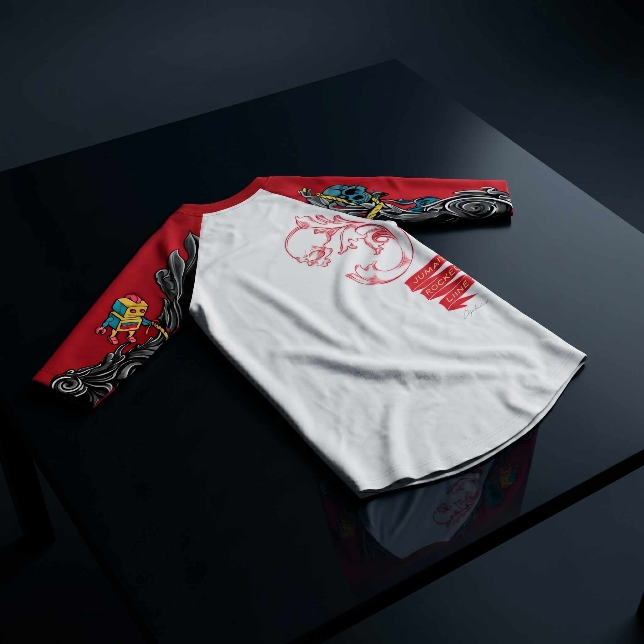 A long-sleeve raglan-style shirt laid flat on a glossy black surface. The torso is white with red graphic artwork and text, and the sleeves are red with black, gray, blue, and yellow illustrated details.