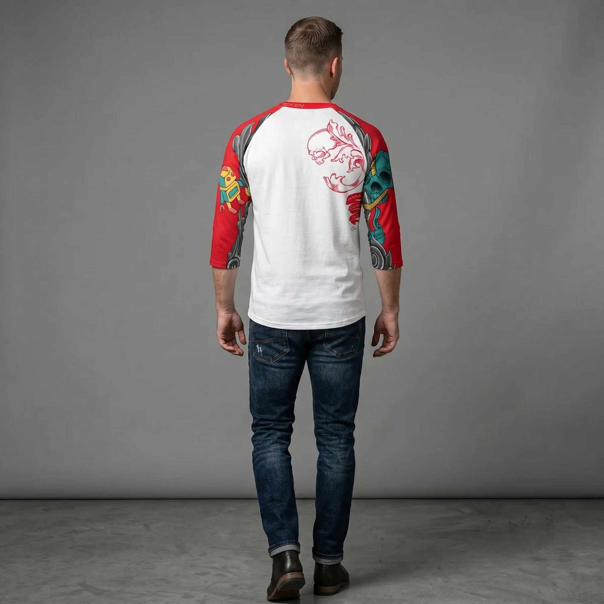 Back view of a model wearing a white and red three-quarter sleeve raglan shirt featuring the HumaNDRoid artwork with colorful mechanical and illustrated elements across the sleeves and upper back.
