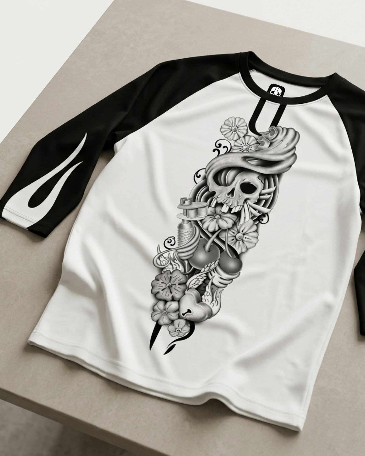 Close-up of a white and black men's three-quarter sleeve raglan shirt featuring the Sakura Revolution artwork with a skull, flowers, flowing ornamental details, and black sleeves.