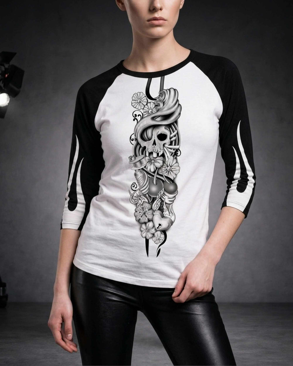 Close-up of a woman wearing a white and black three-quarter sleeve raglan shirt featuring the Sakura Revolution artwork with a skull, flowers, and flowing ornamental details.